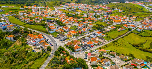 Preview: Small European city in a green valley with a blue sky. Aerial view of the scenic city landscape.