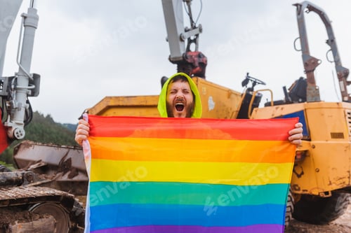 Preview: worker man on a construction site shouts while holding a rainbow lgbt pride flag.