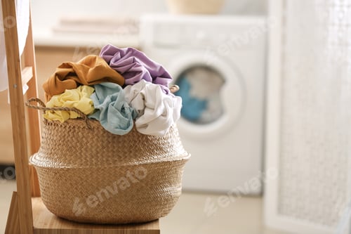 Preview: Wicker basket with dirty clothes on chair in bathroom. Space for text