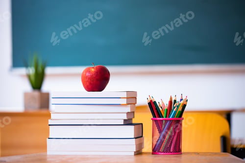 Preview: Pencils and books in the classroom. Education concept.