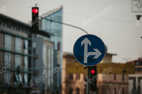 Preview: Selective shot of a traffic sign with two arrows in different directions on a blue background.