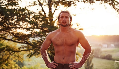 Preview: Beautiful nature. Handsome shirtless man with muscular body type is in the forest at daytime