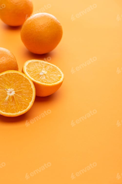 Preview: ripe delicious cut and whole oranges on colorful background