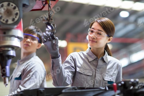 Preview: Young engineers working in the factory