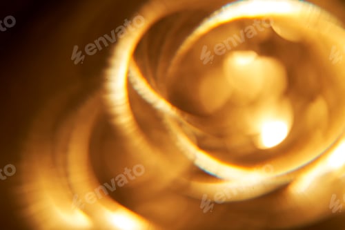 Preview: Abstract festive golden background with bright lines of light.