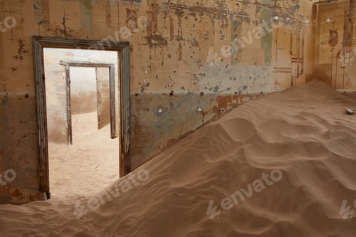 Preview: A view of a room in a derelict building full of sand.