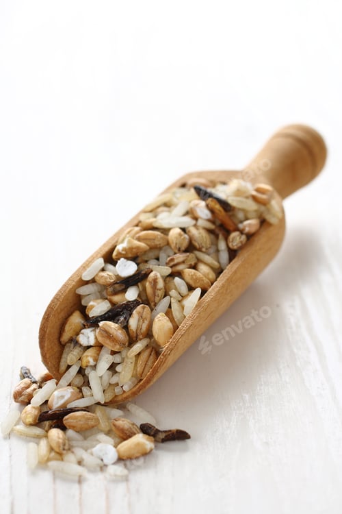 Preview: Uncooked multigrain rice in wooden scoop on white wooden background