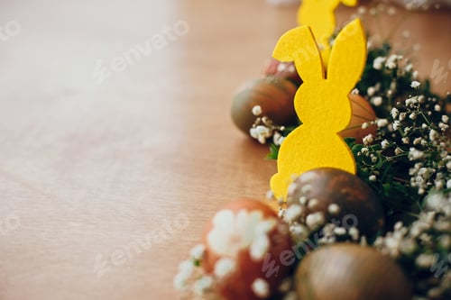 Preview: Stylish easter eggs and yellow bunny on rustic wooden table