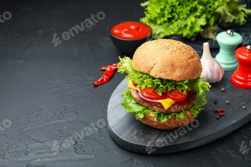 Preview: Delicious hamburger with patty served on black table. Space for text