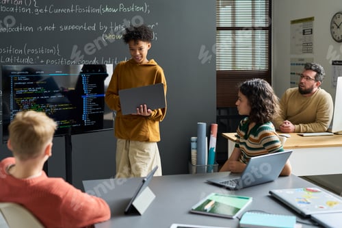 Preview: Teenage Multiethnic Boy Presenting Programming Code to Diverse Classmates