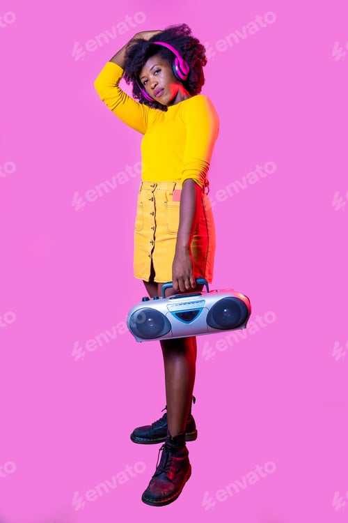 Preview: Young black woman posing isolated background confident holding vintage boombox