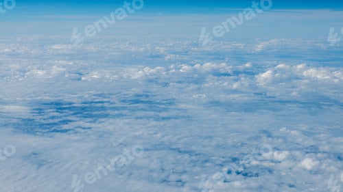 Preview: The beautiful cloudscape with clear blue sky. A view from airplane window.