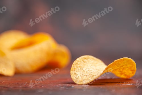 Preview: Close up view of homemade delicious crispy chip laid on dark background