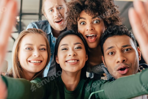 Preview: Young happy multiethnic friends taking selfie in cafe