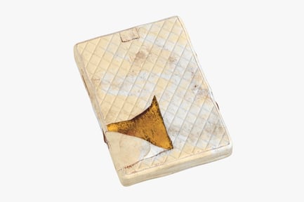 Preview: Mattres Damaged, Worn Beige Rectangular Object with Diamond Pattern and Triangular Cutout