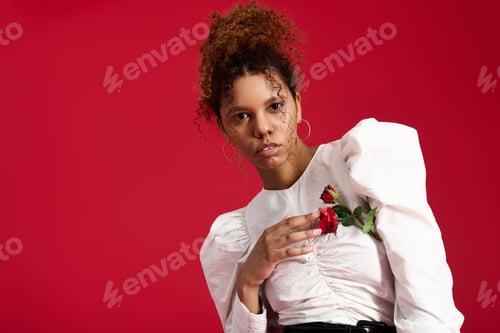 Preview: Young beautiful woman showcases modern fashion with a touch of elegance against a vibrant backdrop