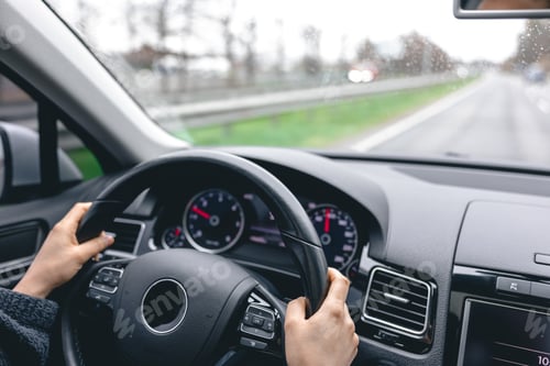 Preview: Woman driver's hands on a car steering wheel.