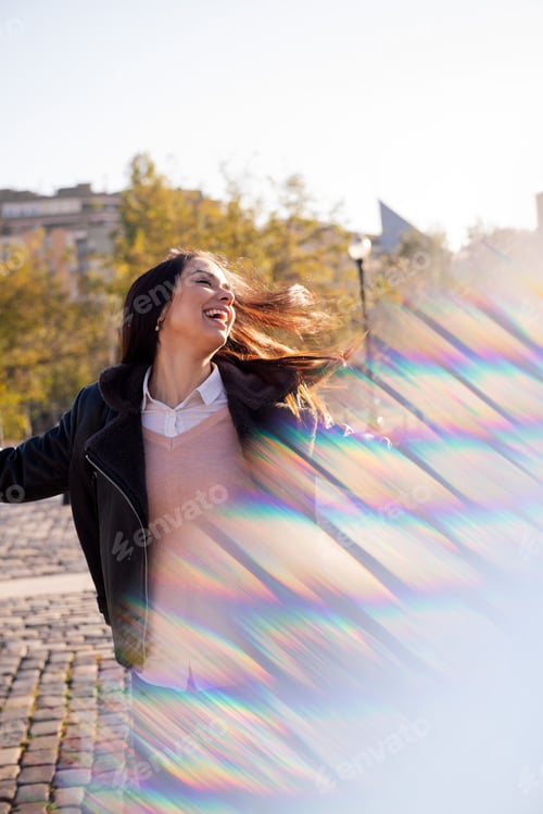 Preview: joyful woman dancing and laughing on the street