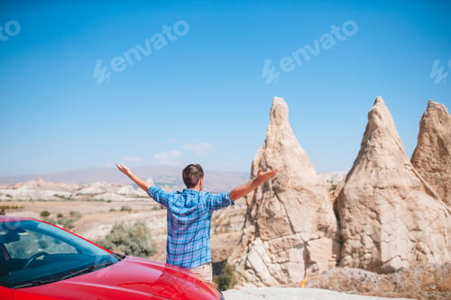 Preview: Happy man on summer vacation in famous place. Cave formations