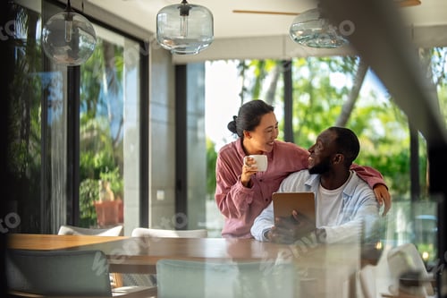 Preview: Multicultural couple working remotely, planning finances and investments online. Digital lifestyle