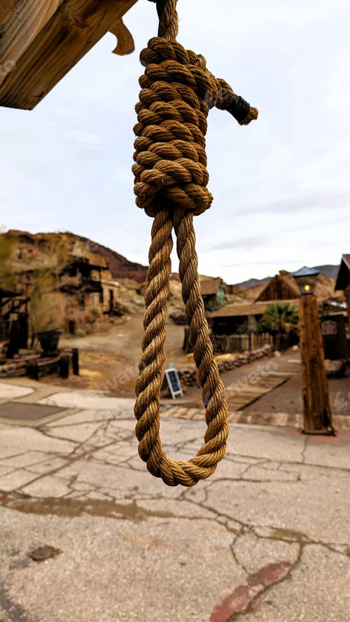 Preview: Rope hanging from the roof of a historic building in a quaint town