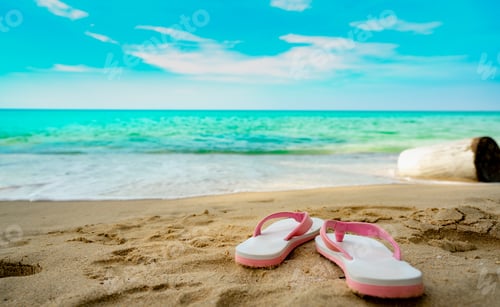 Preview: Pink and white sandals on sand beach. Casual style flip-flop were removed. Summer vacation