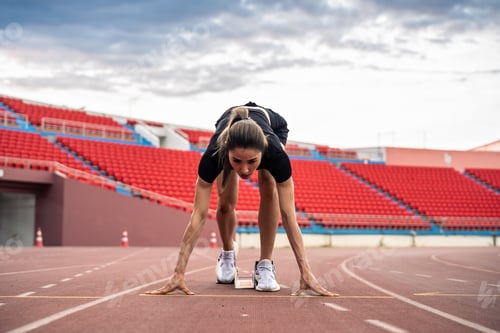 Preview: Asian young sportswoman sprint on a running track outdoors on stadium.
