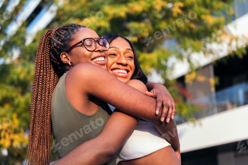 Preview: two young women embracing each other happily