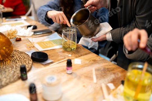 Preview: Pouring melted wax into handmade soy candle jars
