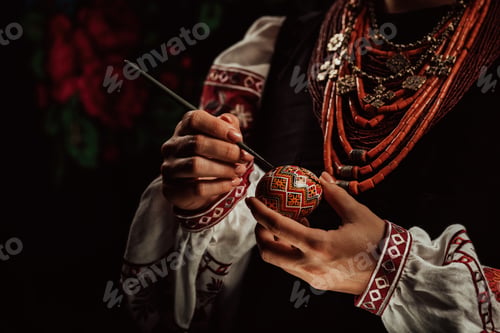 Preview: Ukrainian woman painting traditional ornamets on Easter egg - pysanka