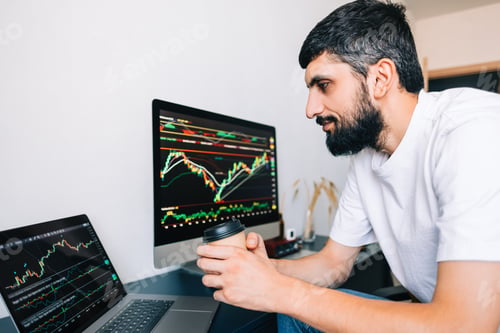 Preview: Caucasian businessman trading online, using computer technology, looking on stock exchange