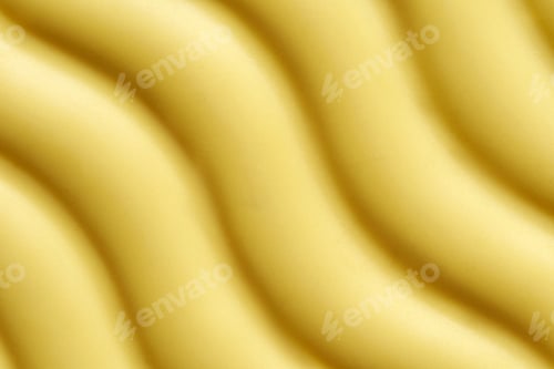 Preview: Close up of yellow wave patterned surface with textured design and soft light