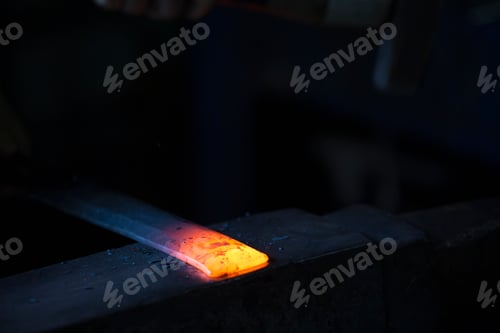 Preview: A length of metal, one end red hot and resting on an anvil.