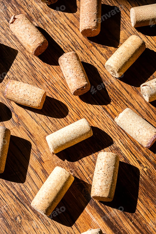 Preview: Wine cork stoppers arranged randomly on wooden surface.