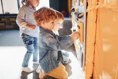 Preview: Three Young Children Playing with an Activity Board