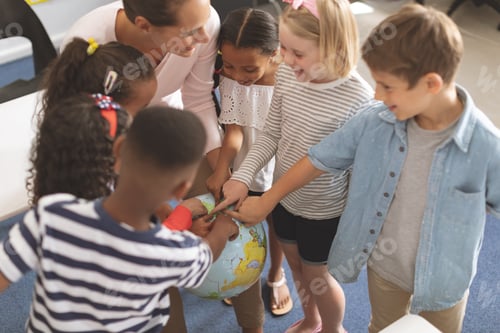Preview: Schoolteacher discussing over earth globe in classroom while she is laughing with his school kids