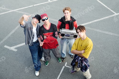 Preview: Group of Young Men Posing on Basketball Court Outdoors