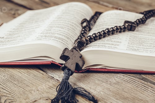 Preview: Bible and a crucifix on an old wooden table. Religion concept