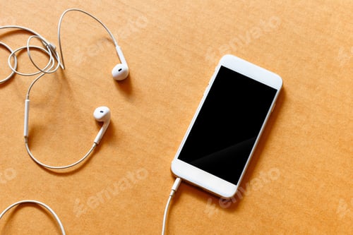 Preview: Blank white smartphone, and earphones on wooden background