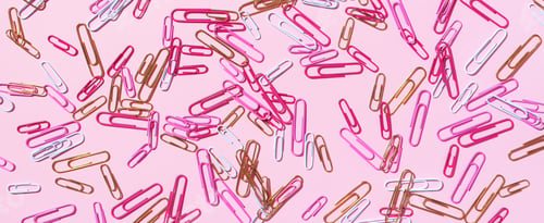 Preview: Pattern of multicolored paper clips on pink background. Back to school. Office, business, paperwork