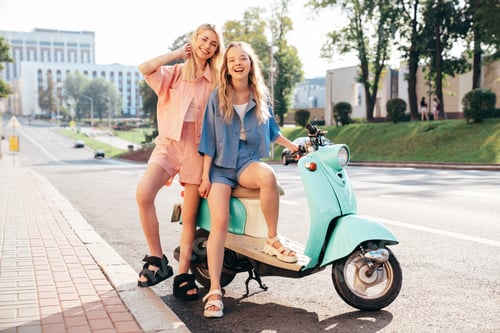Preview: Two girls riding scooter