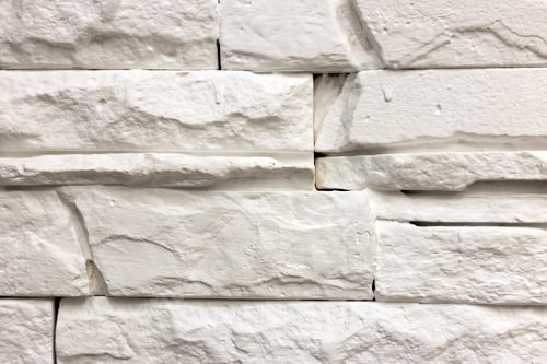 Preview: Close-up of white solid limestone wall or stone fence. Abstract copy space background