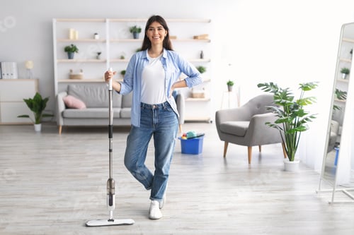 Preview: Portrait of cheerful woman cleaning floor with spray mop, posing