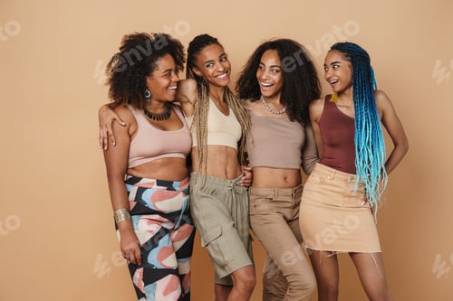 Preview: Young black four women hugging and laughing at camera