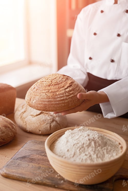 Preview: Crop little baker holding bread