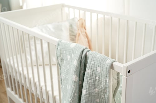 Preview: Wooden white baby crib and toy rabbit close up