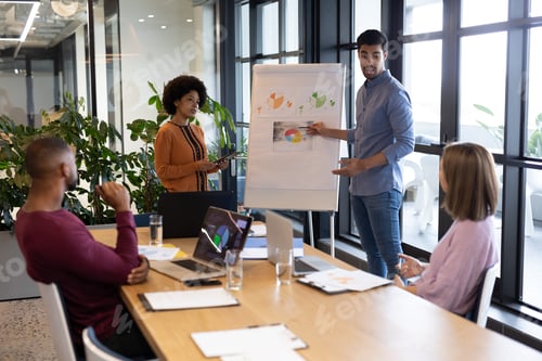 Preview: Diverse group of business people working in creative office