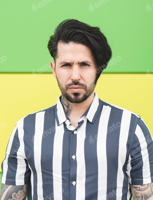Preview: young man very serious on a green background
