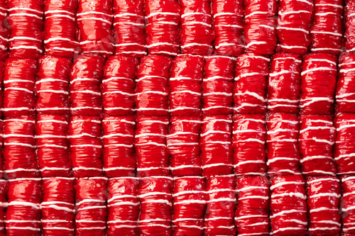Preview: Red colored Turkish dessert baklava placed in rows