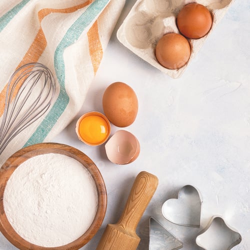 Preview: Ingredients for baking - flour, wooden spoon, eggs.